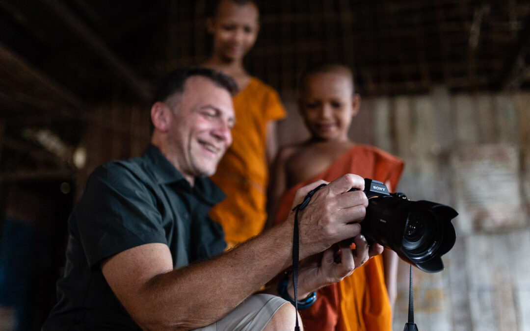 Laurent showing the pictures we took of novice monks